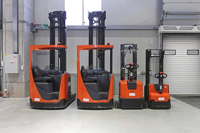 industrial forklifts in busy warehouse